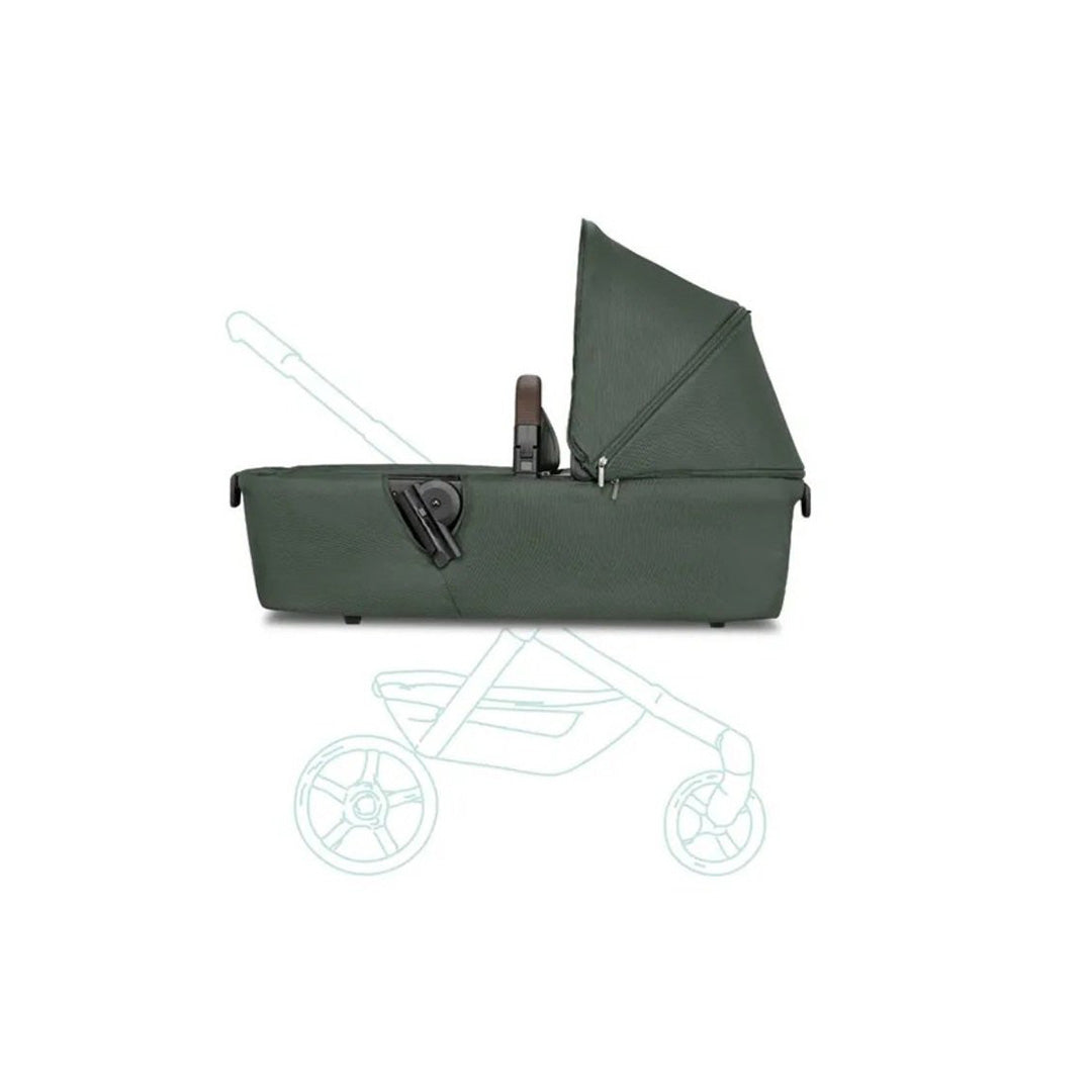 The Joolz Aer+ stroller with the attached carrycot folded flat and stored inside a small car trunk, showcasing its space-saving design perfect for family road trips.