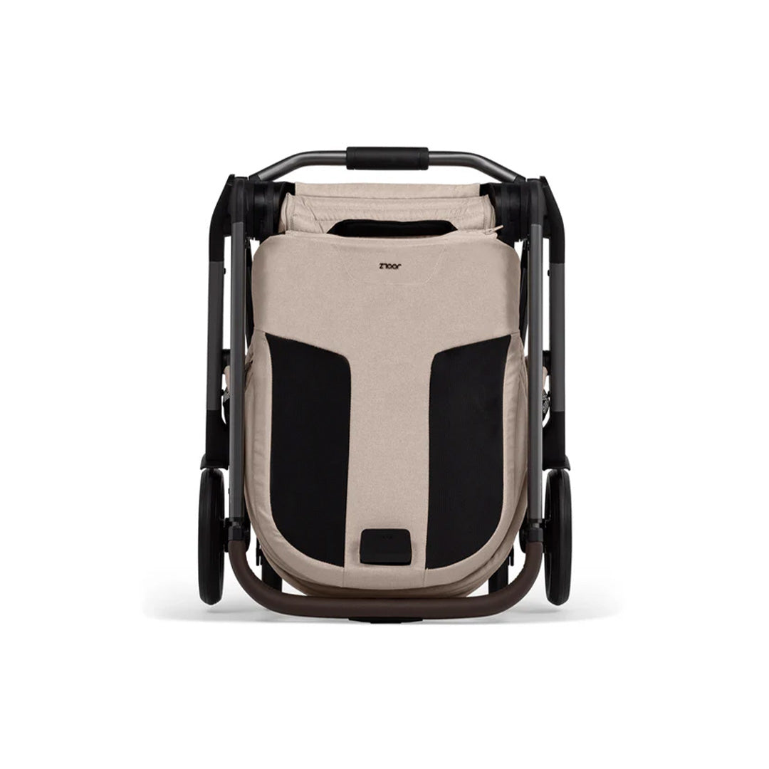 The Joolz Hub² in Sandy Taupe folded into its ultra-compact, self-standing form (66 X 52 X 26 cm), perfect for easy hallway storage.