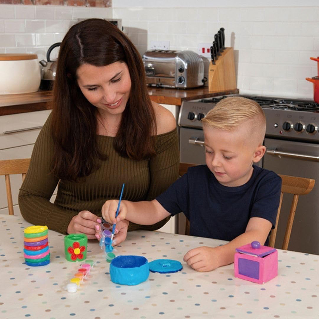 Child creating a coil pot with educational toys for kids clay tools.
