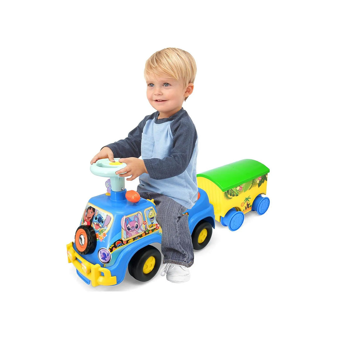 A toddler sitting on the ride on car, engaging with the Interactive Dashboard Activities